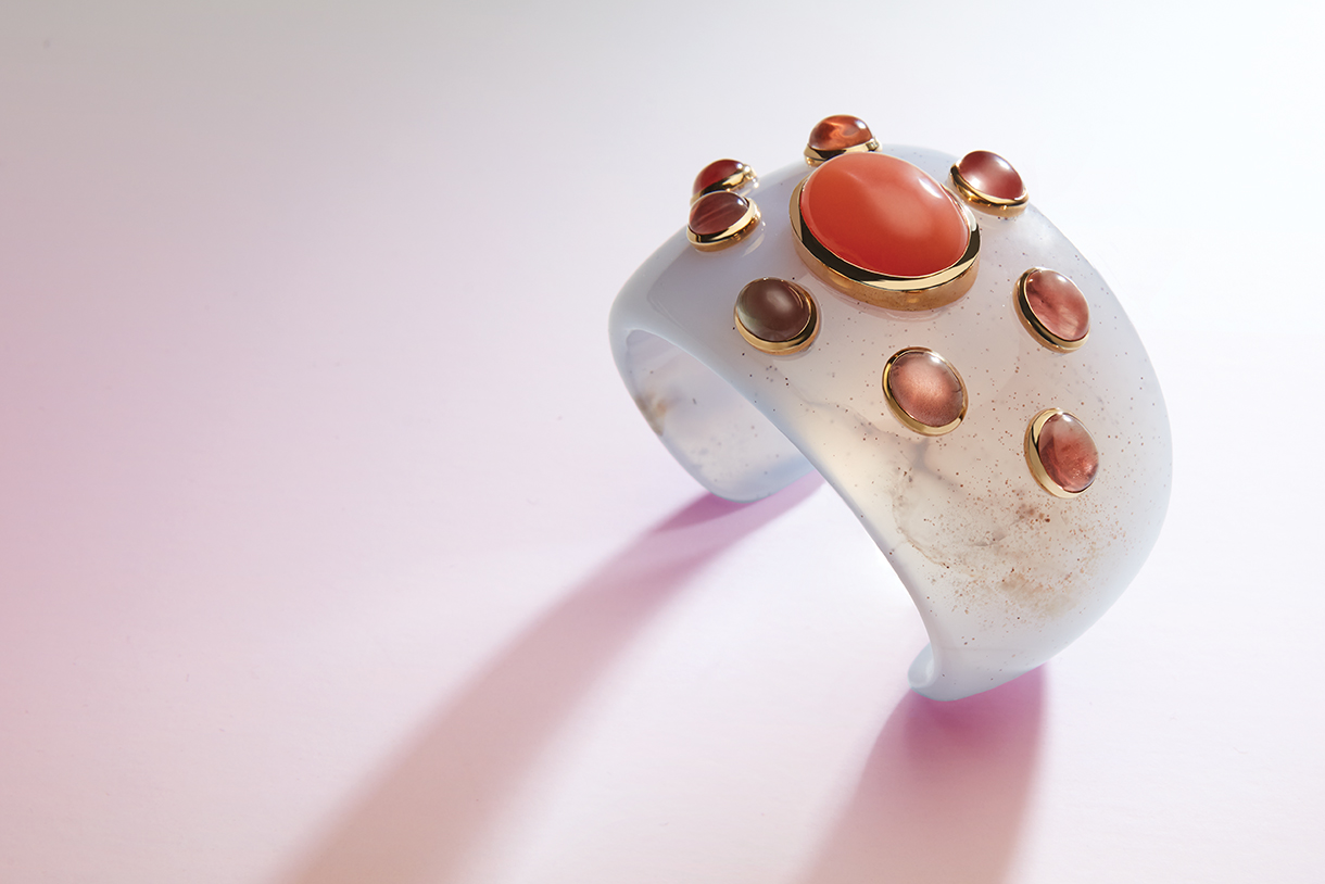 Sunstones and Moonstones set in gold on a white stone bracelet cuff